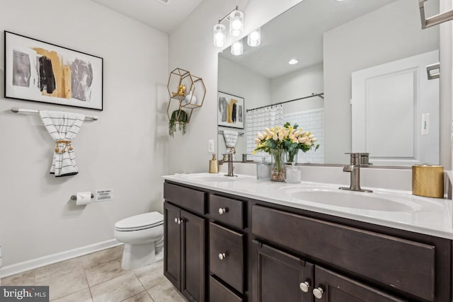 full bathroom featuring double vanity, a sink, toilet, and tile patterned floors