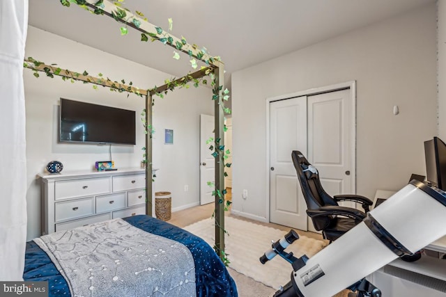 bedroom with a closet and baseboards