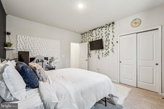 bedroom featuring a closet and light carpet