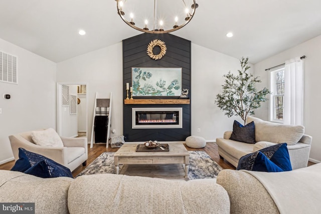 living room with a large fireplace, baseboards, visible vents, wood finished floors, and vaulted ceiling