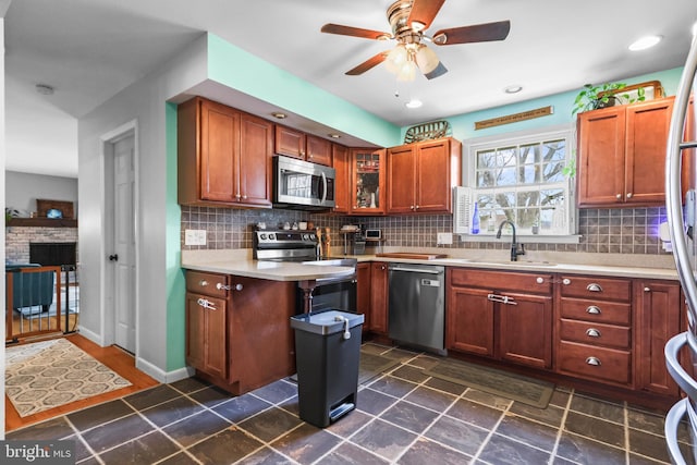 kitchen with decorative backsplash, appliances with stainless steel finishes, light countertops, and a sink