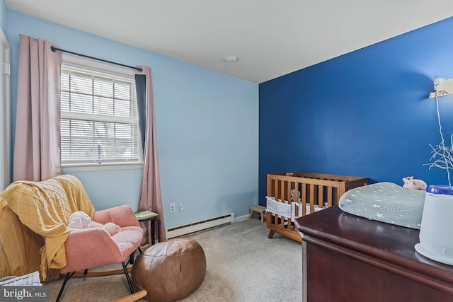 carpeted bedroom with a baseboard heating unit and baseboards