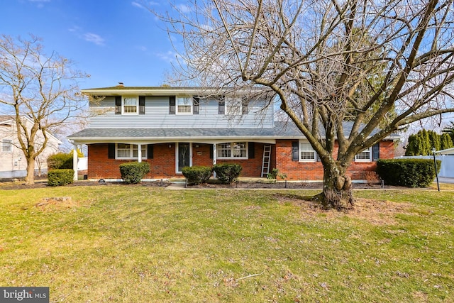 traditional-style home with a front lawn and brick siding