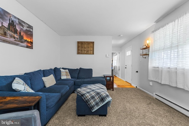 carpeted living room with a baseboard heating unit and baseboards