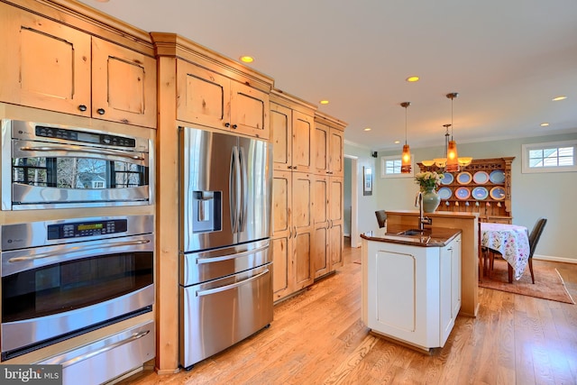 kitchen with a warming drawer, recessed lighting, light wood-type flooring, and stainless steel appliances