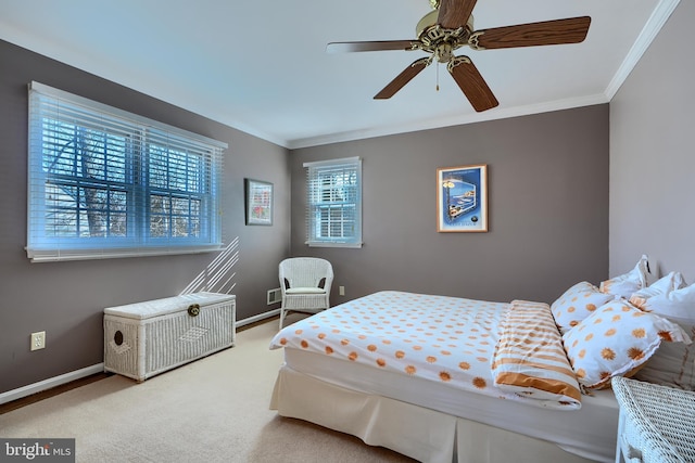 carpeted bedroom featuring a ceiling fan, crown molding, and baseboards