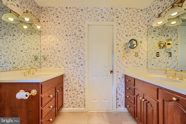 full bathroom featuring a sink, two vanities, and wallpapered walls