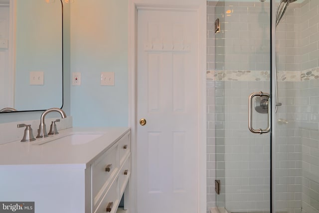 bathroom with a stall shower and vanity