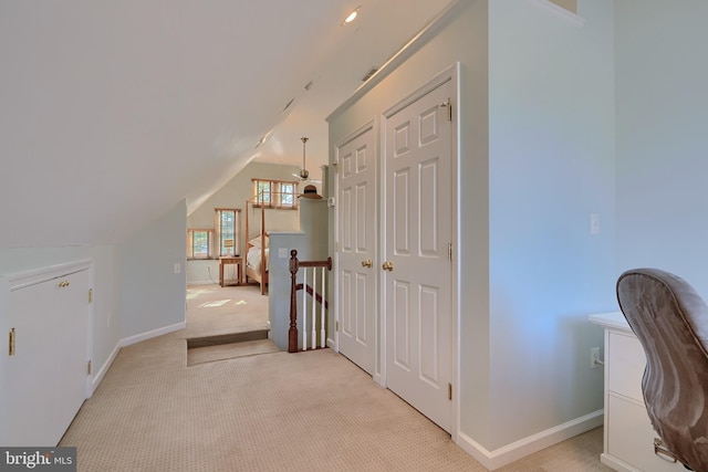 bonus room with baseboards, light carpet, and lofted ceiling