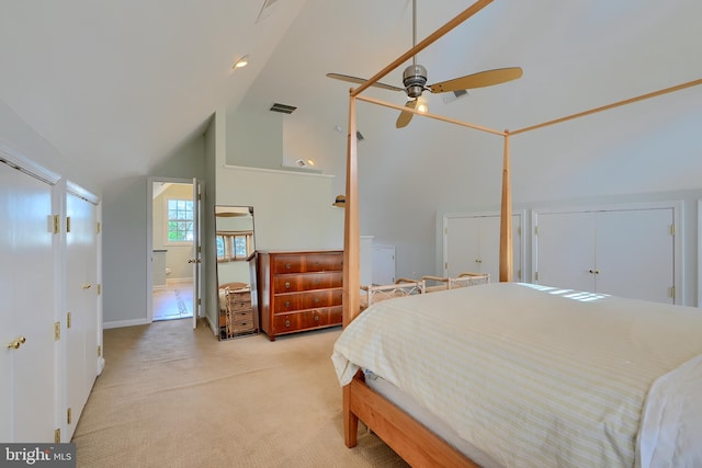 bedroom featuring visible vents, light colored carpet, high vaulted ceiling, and ceiling fan