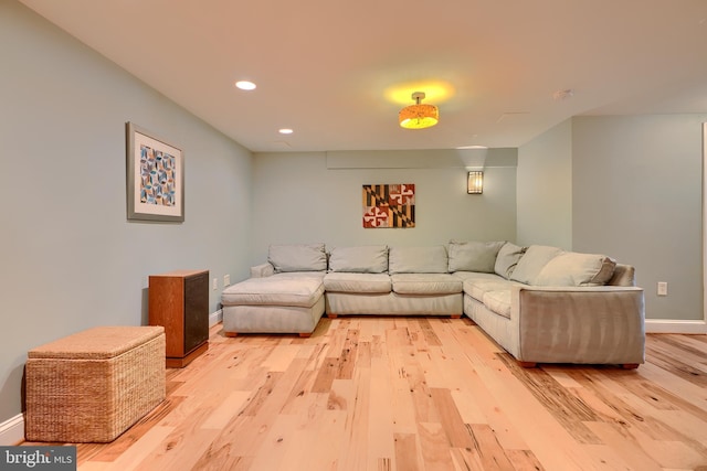 living room with light wood finished floors, recessed lighting, and baseboards