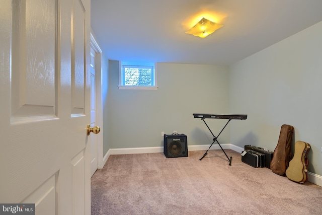 misc room with baseboards and carpet