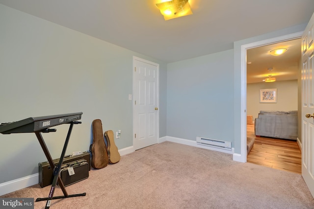 workout area with a baseboard heating unit, baseboards, and carpet floors