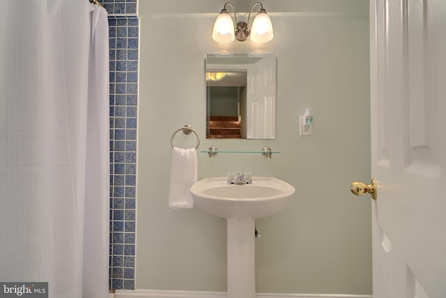 bathroom with a sink and a shower with curtain