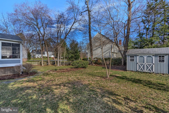 view of yard featuring a storage shed and an outdoor structure