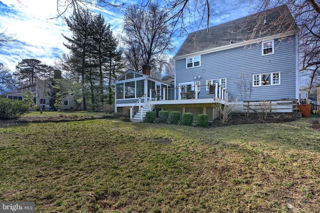 back of property featuring stairs, a yard, and a sunroom