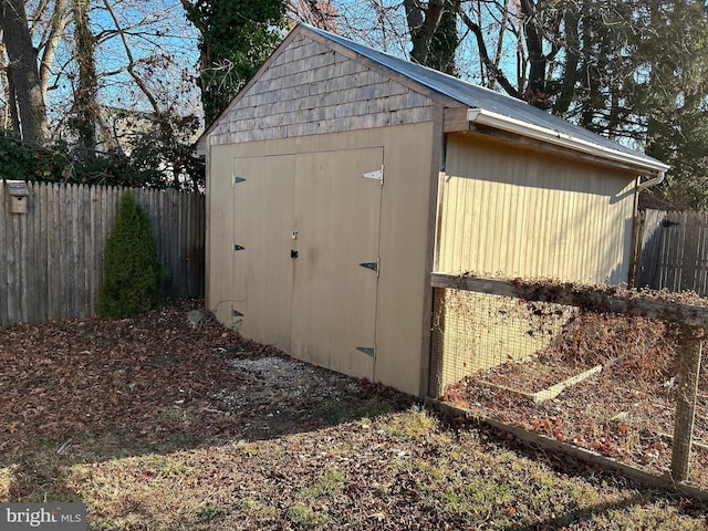 view of shed featuring fence