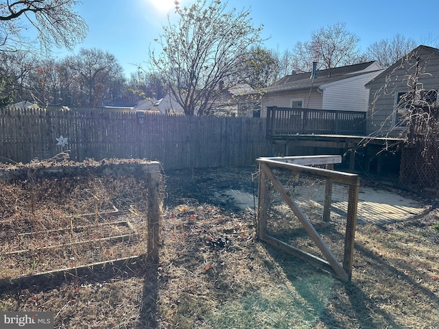 view of yard with fence and a wooden deck