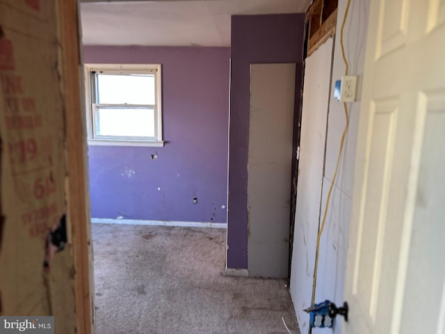 unfurnished bedroom with carpet floors and baseboards