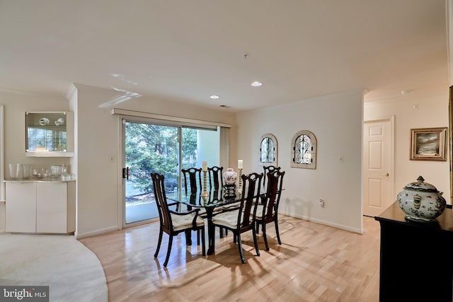 dining area with ornamental molding, light wood finished floors, recessed lighting, and baseboards