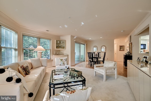 living area featuring light wood-style floors, recessed lighting, and crown molding