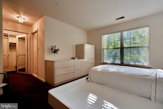 bedroom with visible vents and a spacious closet