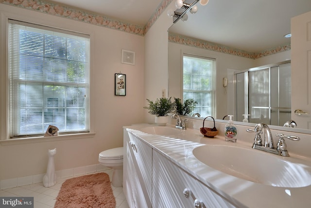 full bath featuring a stall shower, a sink, toilet, and tile patterned floors