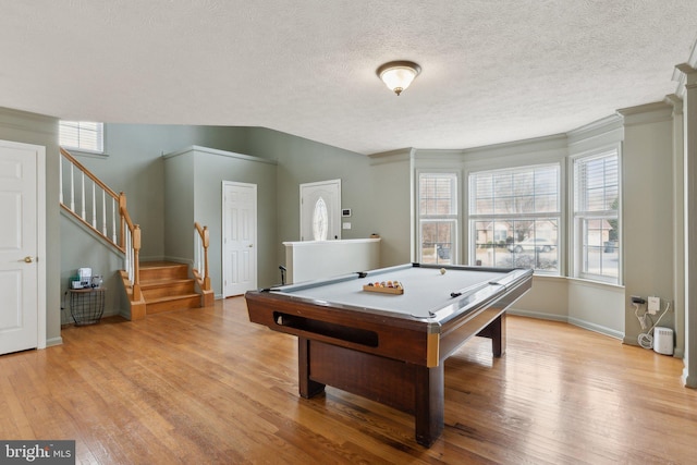 playroom with light wood finished floors, baseboards, a textured ceiling, and pool table