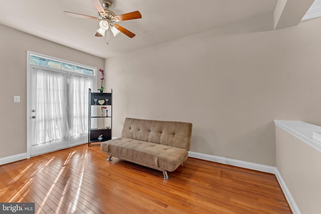 sitting room featuring ceiling fan, hardwood / wood-style floors, and baseboards