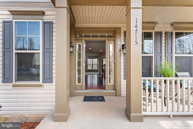 view of exterior entry with covered porch