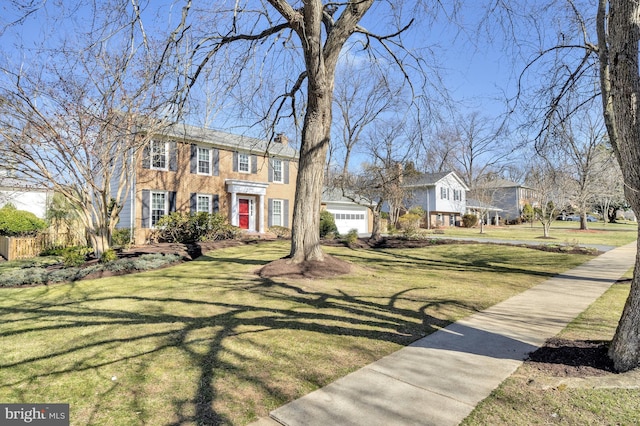 view of front of property with an attached garage and a front lawn