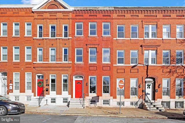 view of front of property featuring entry steps and brick siding