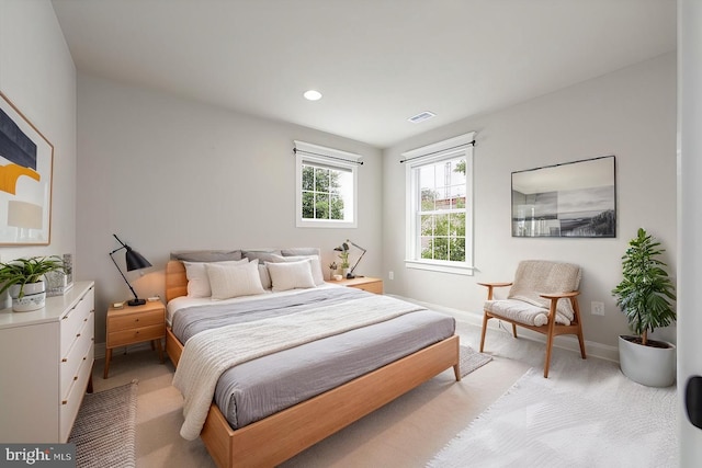 bedroom featuring recessed lighting, visible vents, baseboards, and light colored carpet