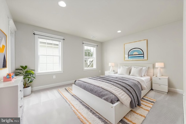 bedroom with visible vents, recessed lighting, light colored carpet, and baseboards