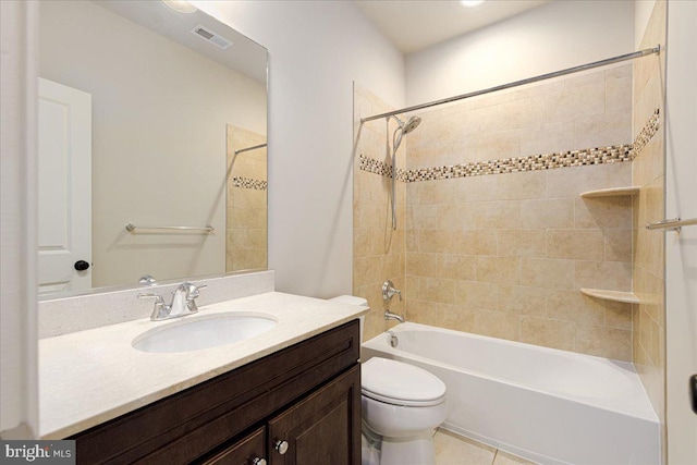 bathroom featuring vanity, washtub / shower combination, visible vents, tile patterned floors, and toilet