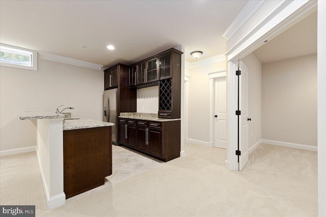 bar with light carpet, stainless steel refrigerator with ice dispenser, and ornamental molding