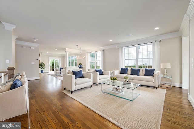 living room featuring wood finished floors, baseboards, and ornamental molding