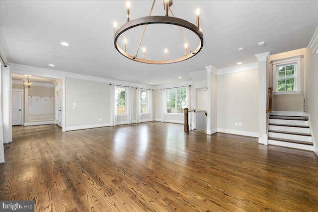 unfurnished living room featuring recessed lighting, a notable chandelier, wood finished floors, and baseboards