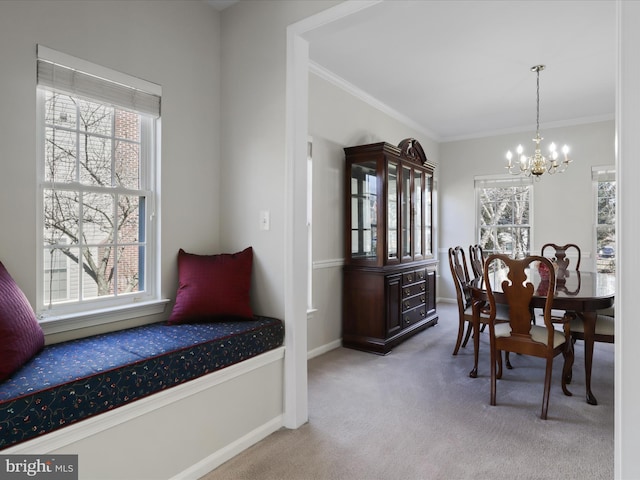 dining room with a chandelier, baseboards, carpet, and ornamental molding