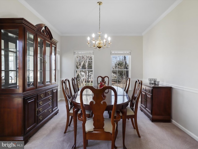 carpeted dining area with baseboards, crown molding, and an inviting chandelier