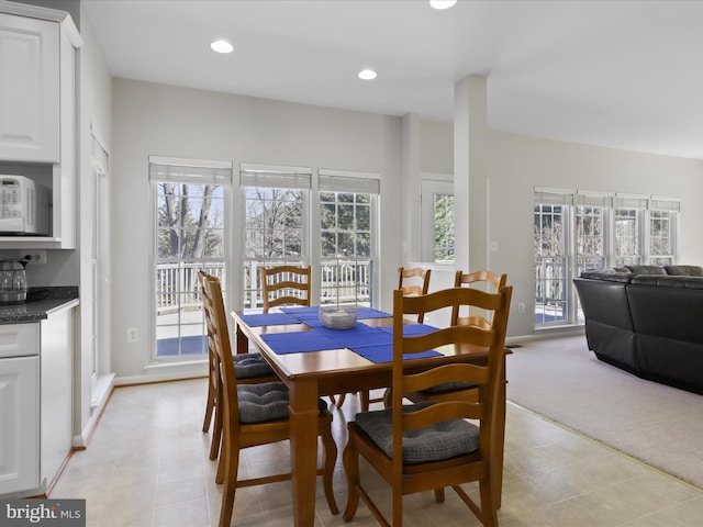 dining area featuring light tile patterned floors, recessed lighting, baseboards, and light carpet