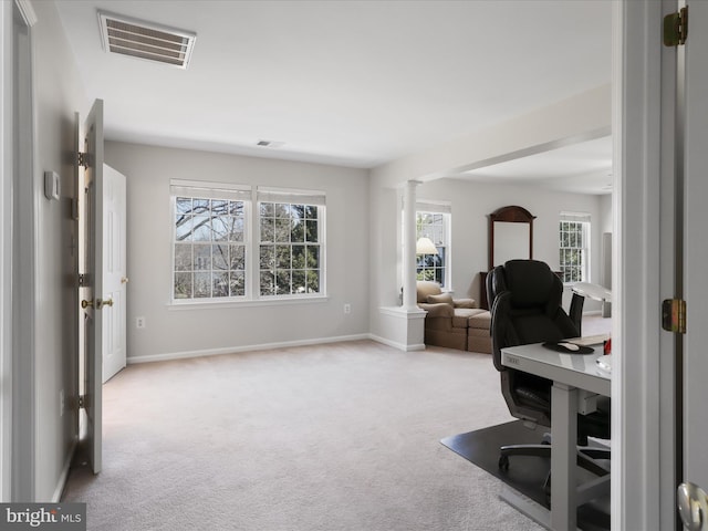 office space featuring visible vents, baseboards, carpet, and ornate columns