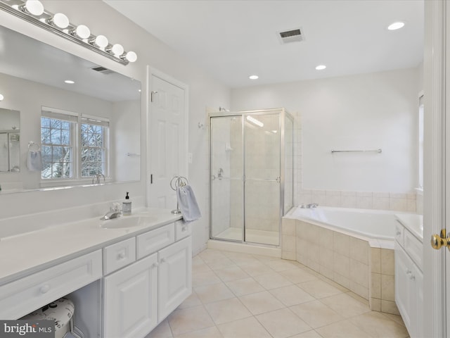 full bathroom with a bath, tile patterned flooring, a stall shower, and vanity