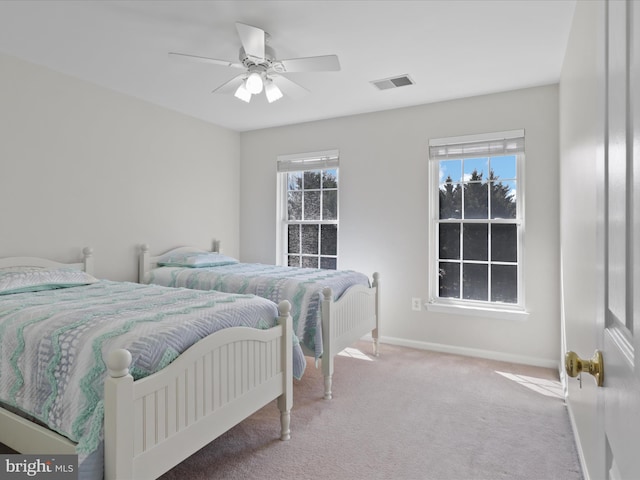 bedroom featuring visible vents, carpet floors, baseboards, and ceiling fan