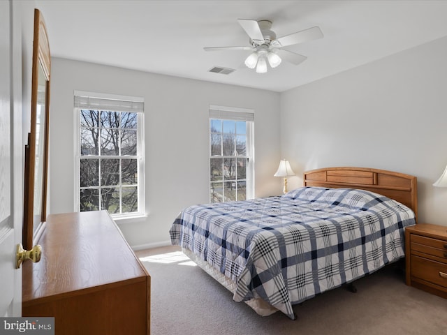 carpeted bedroom with visible vents and ceiling fan