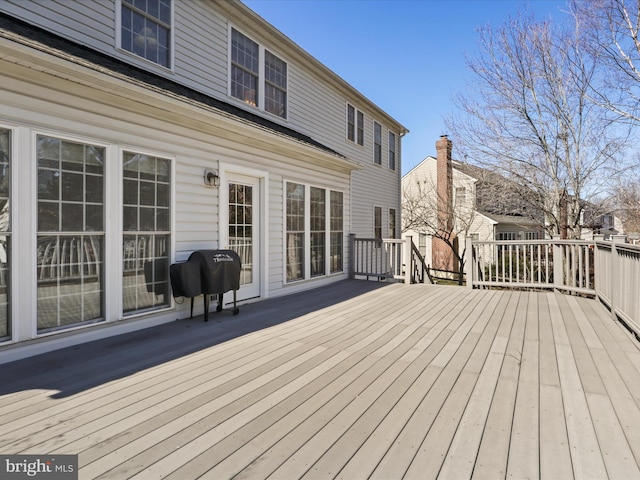 wooden terrace with a grill