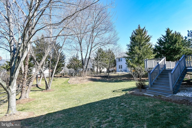 view of yard with stairs and a deck