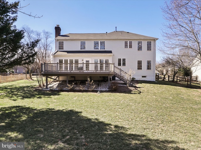 rear view of house featuring a wooden deck, a yard, fence, and a chimney