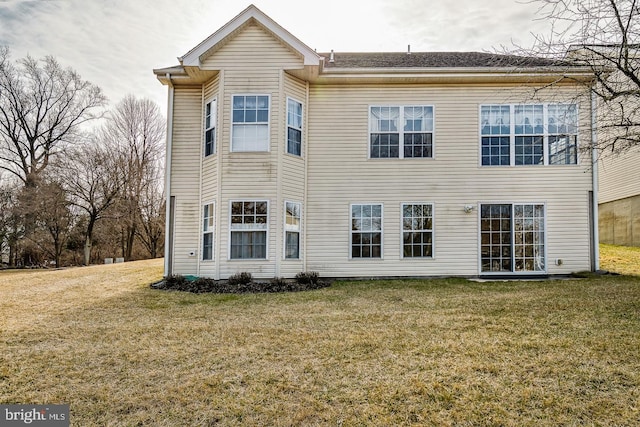 rear view of property with a lawn