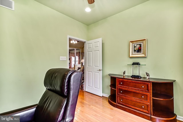 office with ceiling fan, hardwood / wood-style floors, visible vents, and baseboards